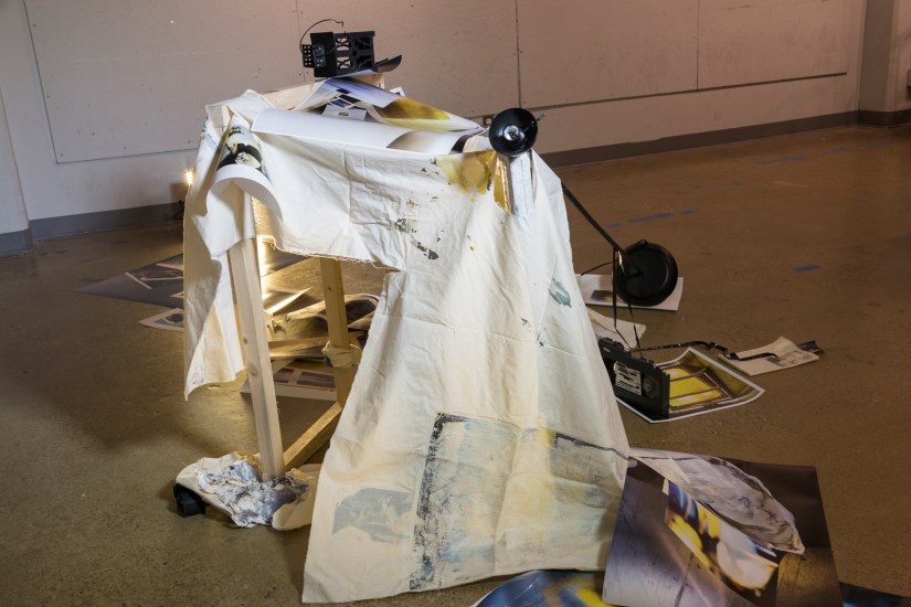 Ruins for Tomorrow, 2016 | Printed digital photographs, silk screen, canvas frame, vinyl records, video cassette, binoculars, surveillance camera, muslin, lamp stand, lantern, broken light bulb, and light kit 